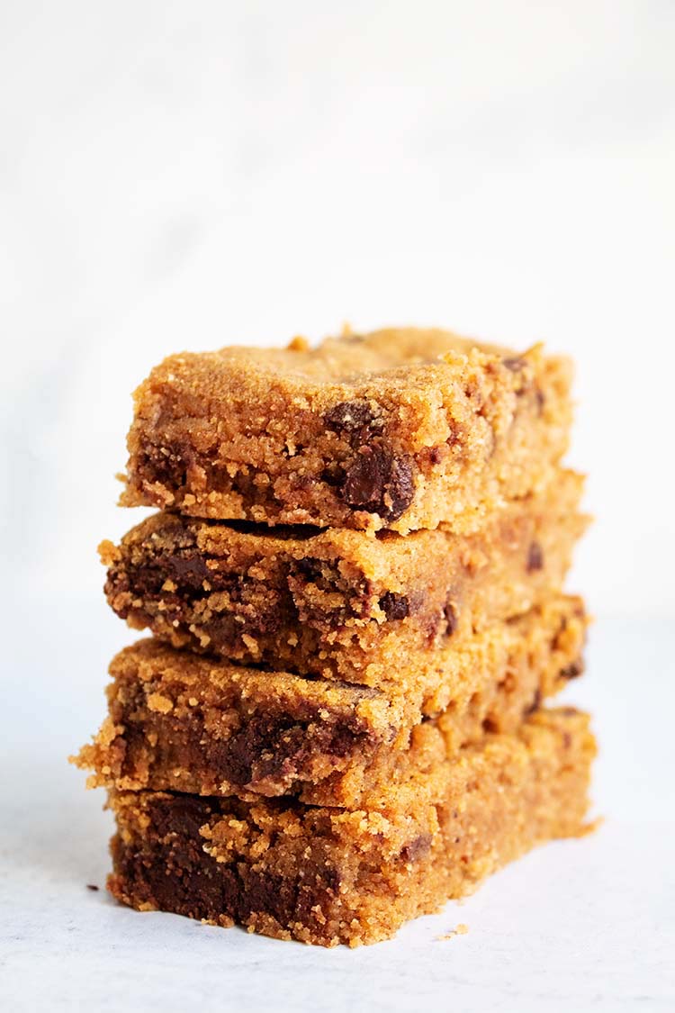 stack of four rectangular shaped pumpkin chocolate chip cookies placed on a white countertop
