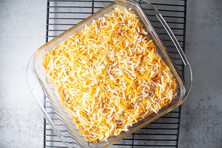 overhead view of buffalo chicken casserole with cauliflower rice and topped with cheese