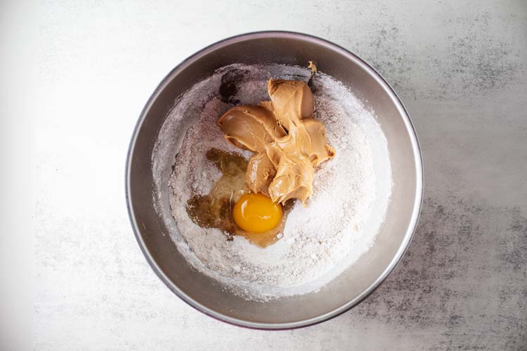 bowl with flour mixture, egg, and peanut butter