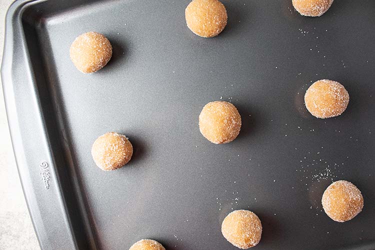 overhead view of peanut butter blossom cookie dough balls on cookie sheet