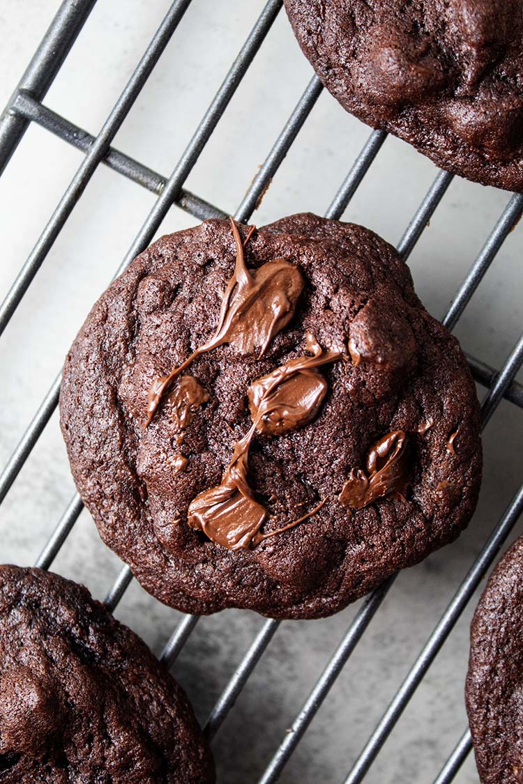 overhead view of chocolate chocolate chip cookies on a cooling rack