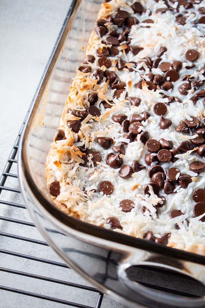 overhead view of 7-layer magic bars with peanut butter crust in a glass casserole dish and ready to serve