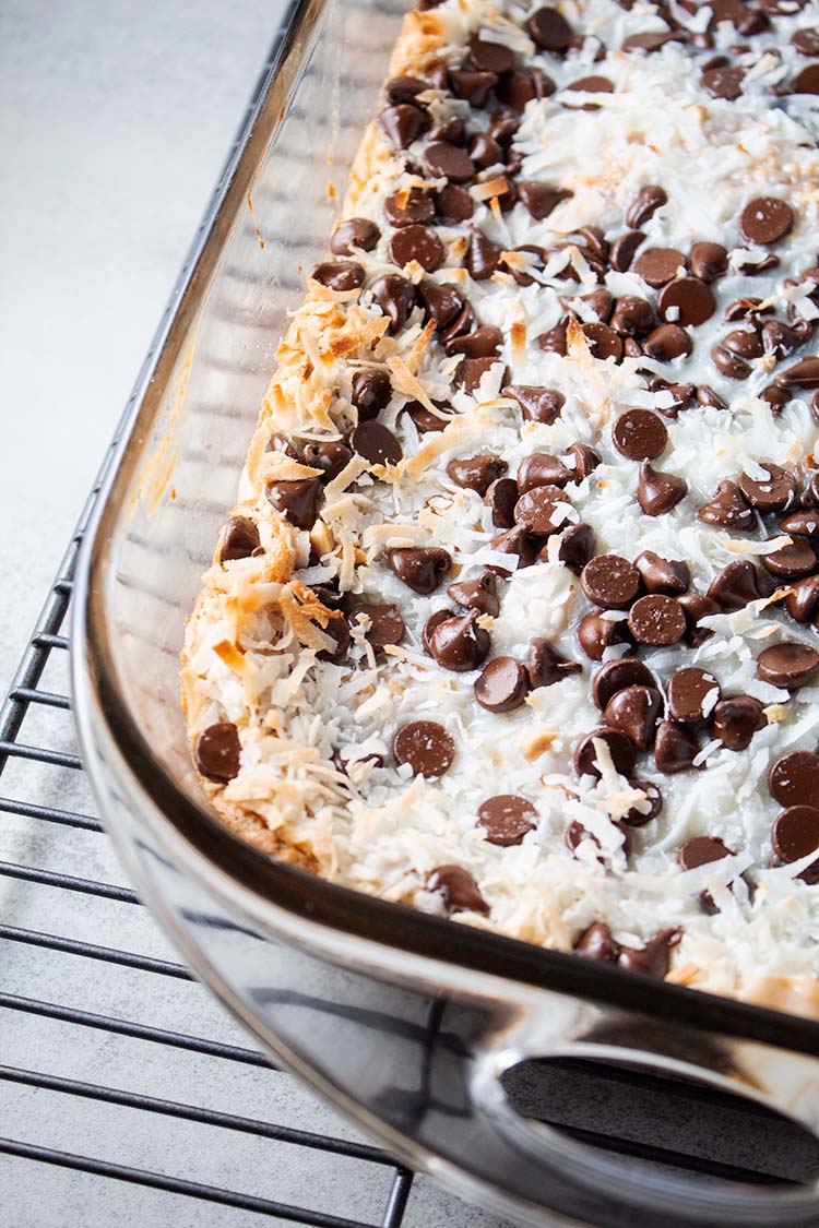 overhead view of 7-layer magic bars with peanut butter crust in a glass casserole dish and ready to serve