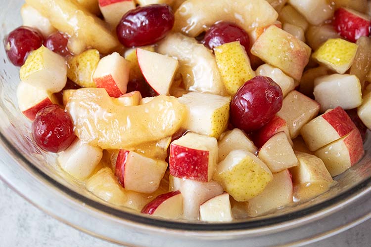 overhead view of glass serving bowl with ready to serve autumn fruit salad recipe