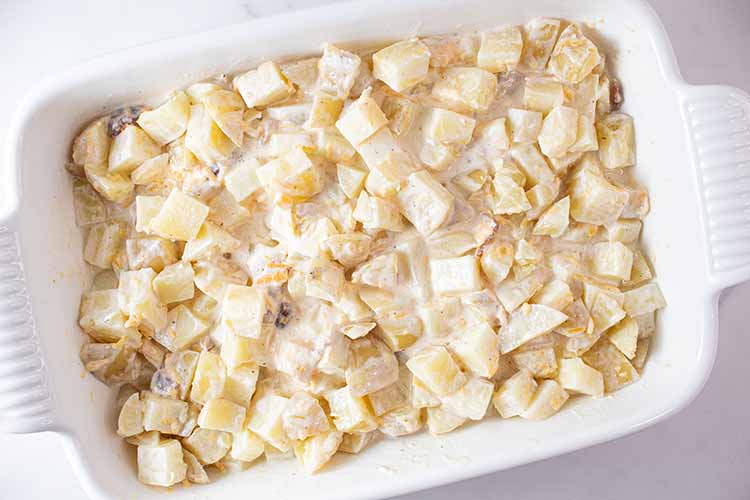 overhead view of potatoes with cheesy mixture poured on top