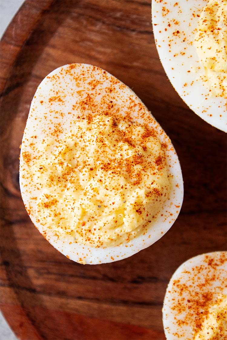 overhead view of classic deviled eggs topped with paprika and ready to serve