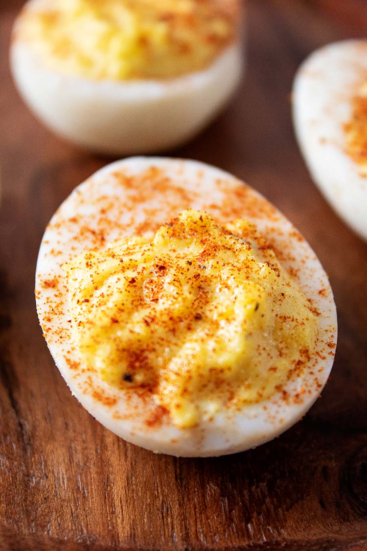 sideview of easy deviled eggs topped with paprika and ready to serve
