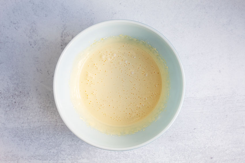 overhead view of egg mixture thoroughly combined in white bowl