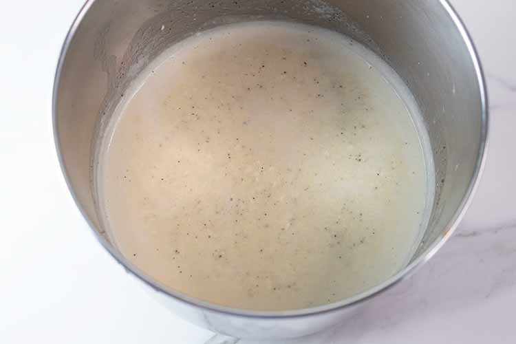 overhead view of melted cream cheese, butter, heavy whipping cream and spices ready to be combined