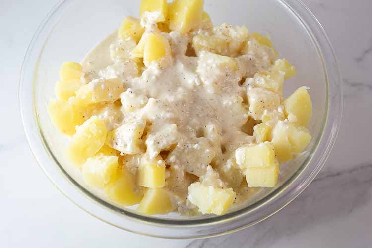 overhead view of boiled potatoes ready to be mashed and combined with cream mixture