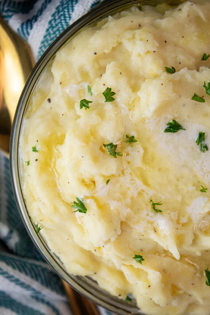 overhead view of creamy homemade mashed potates in a serving bowl