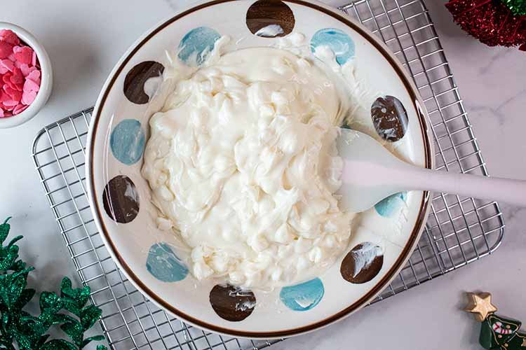 overhead view of sweetened condesnsed milk and melted chocolate in a bowl ready to be mixed