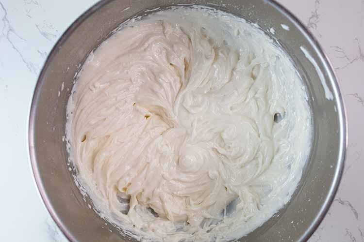 overhead view of yogurt and pudding mix thoroughly combined in mixing bowl