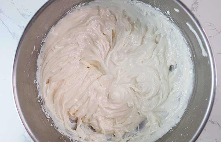 overhead view of combined yogurt and pudding mixture in mixing bowl
