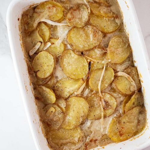 overhead view of white casserole dish with ready to serve scalloped potatoes