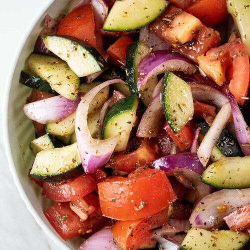 overhead view of cucumber tomato salad in a bowl ready to serve