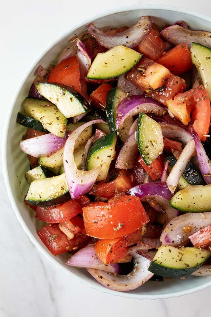 overhead view of cucumber tomato salad in a bowl ready to serve