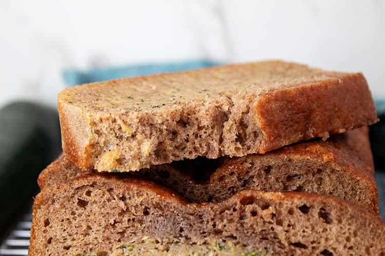 sideview of high protein zucchini bread sliced and ready to serve