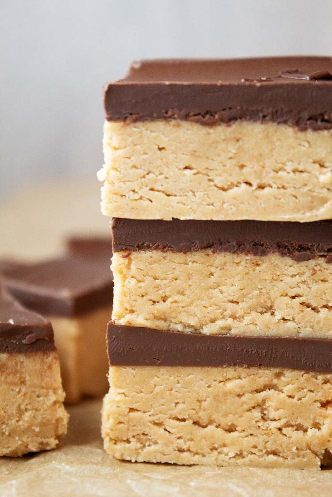 sideview of a stack of three no-bake peanut butter bars ready to be served