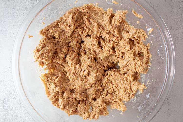 overhead view of all peanut butter base ingredients combined and ready to be poured into the glass casserole dish