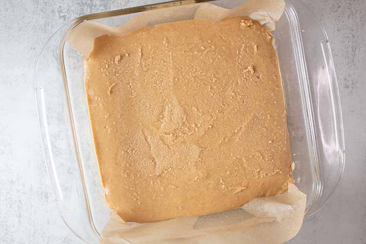 overhead view of peanut butter mixture added to the glass casserole dish
