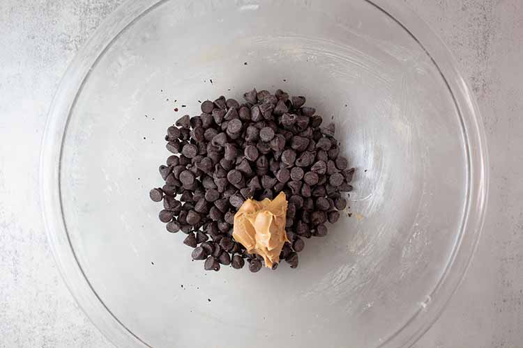 overhead view of chocolate and butter added to the glass mixing bowl ready to be melted and combined