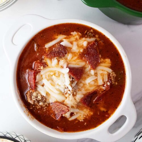 overhead view of pizza soup in a white bowl ready to serve