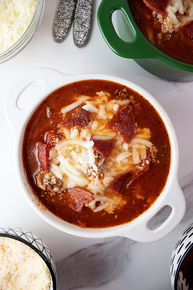 overhead view of pizza soup in a white bowl ready to serve